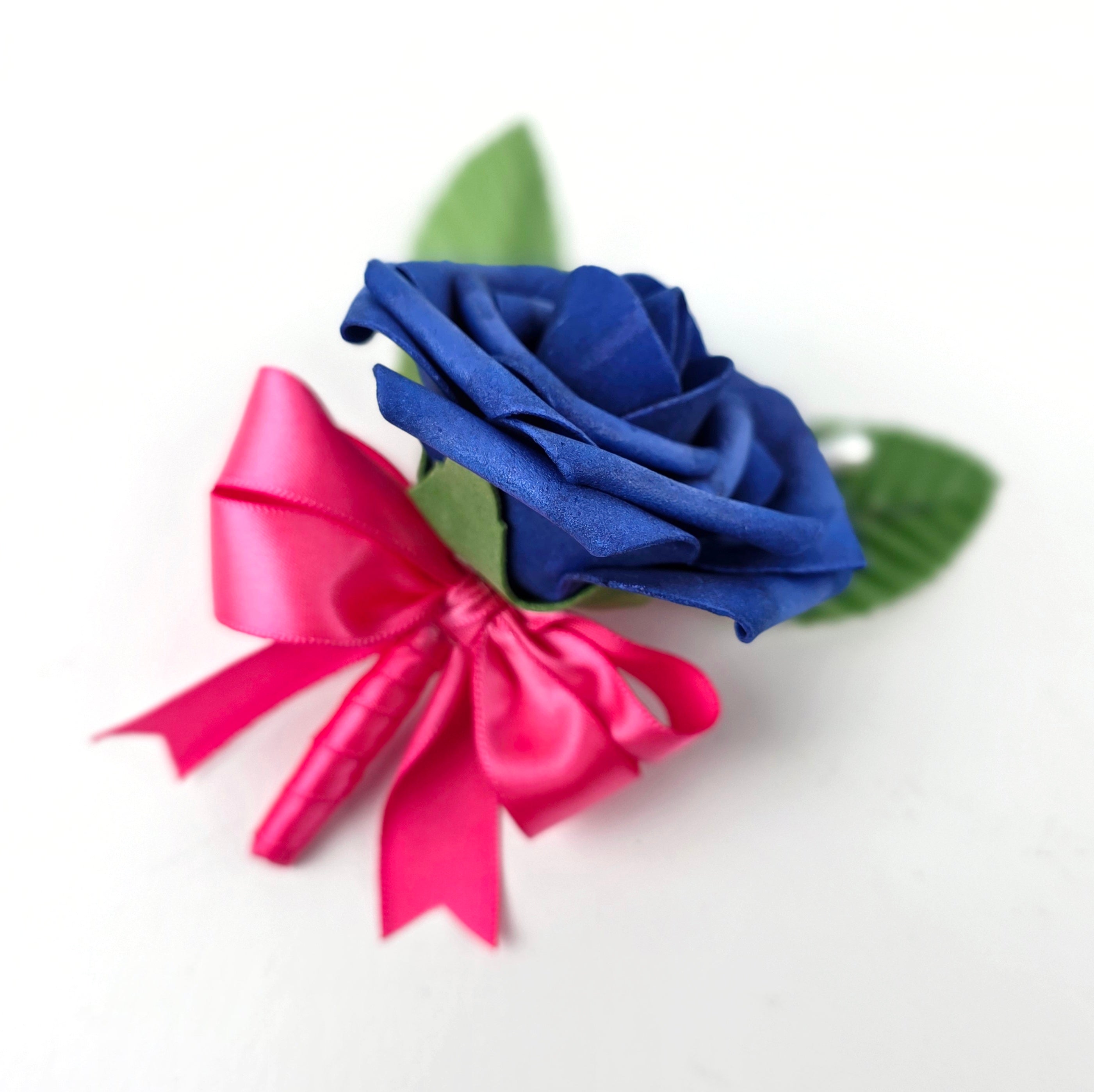 Royal blue boutonniere with hot pink ribbon and pearl pin