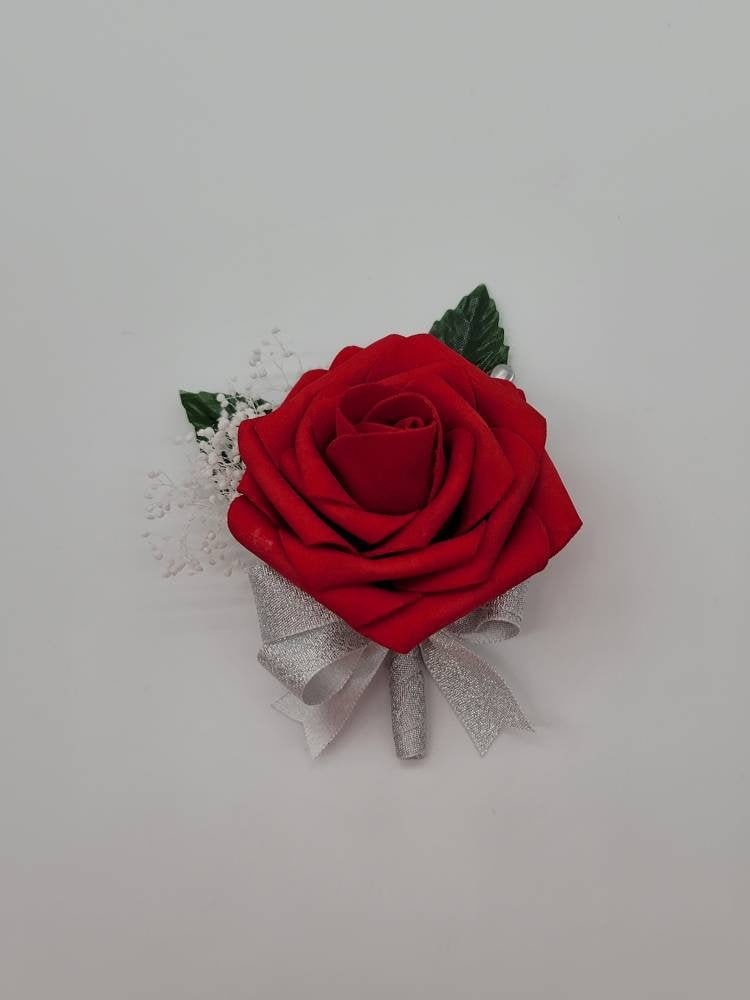 Red rose boutonniere with baby's breath and silver ribbon. faux leaves. Made form real touch roses. Pearl pin
