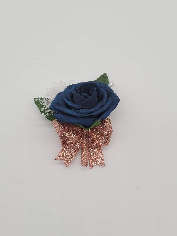 Navy blue boutonniere with Rose gold ribbon and baby's breath