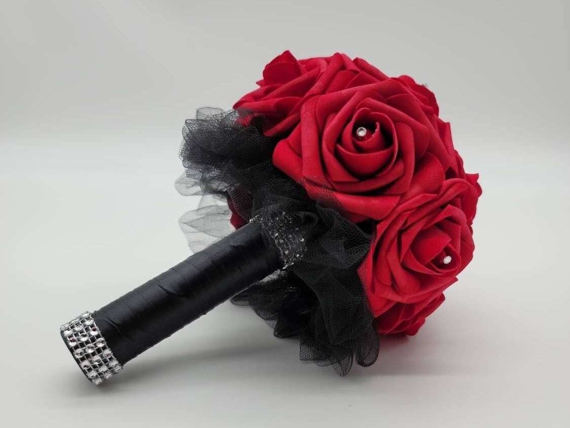 6 inch toss bouquet with red roses. Handle is made using black satin ribbon and finished with silver bling wrap. rhinestones are in the center of Evey rose. Great for Bridal bouquets, Bridesmaid bouquets, Prom, Homecoming, Quinceanera's