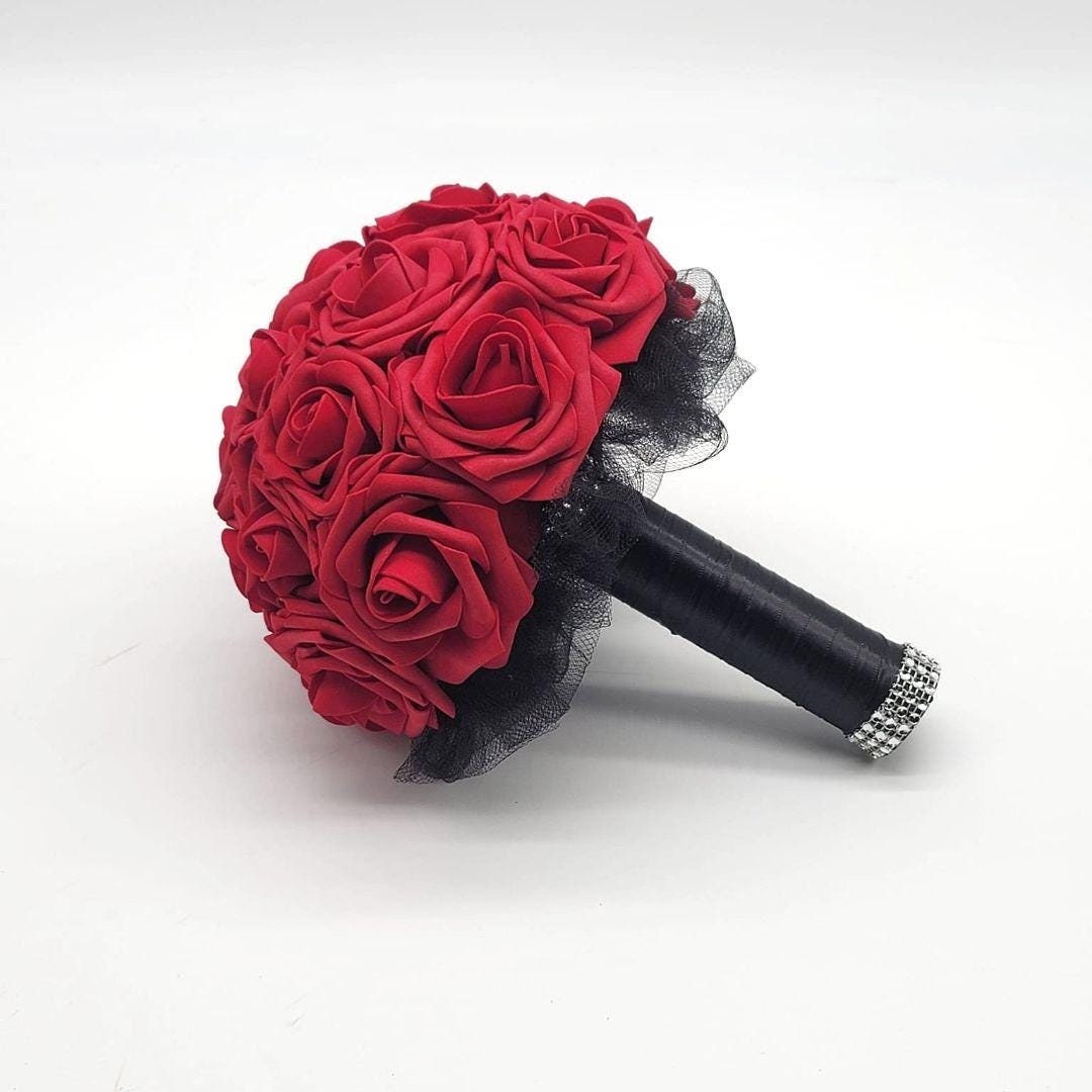 Red bouquet made from Real Touch Roses. Handle is made up of black tulle and satin ribbon and finished with silver bling wrap.