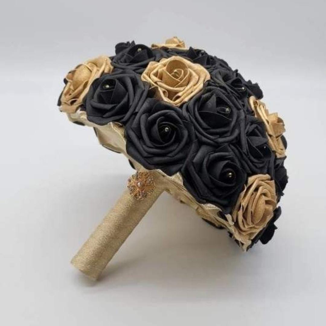 Black and gold bridal bouquet made with real touch roses. Rhienstones on every flower. gold brooch on handle.
