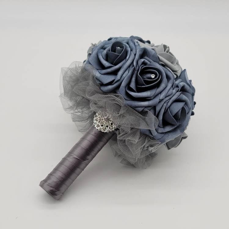 Dusty blue bouquet with gray tulle and silver brooch