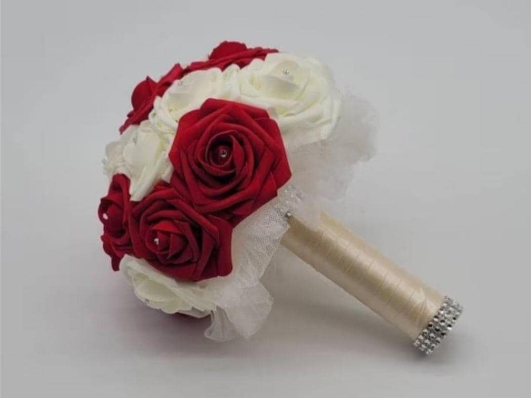 Red and Ivory Wedding bouquet with ivory tulle and ivory satin ribbon. Finished with a silver bling wrap. Rhinestones on every rose.
