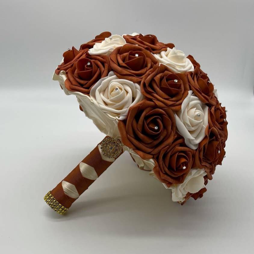 Burnt Orange and cream wedding bouquet with burnt orange and ivory ribbon.