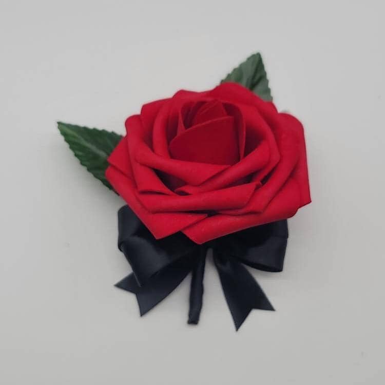 Red and Black Boutonniere with 2 faux leaves. Handle is made using satin black ribbon