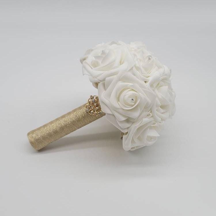 White bouquet with gold ribbon
