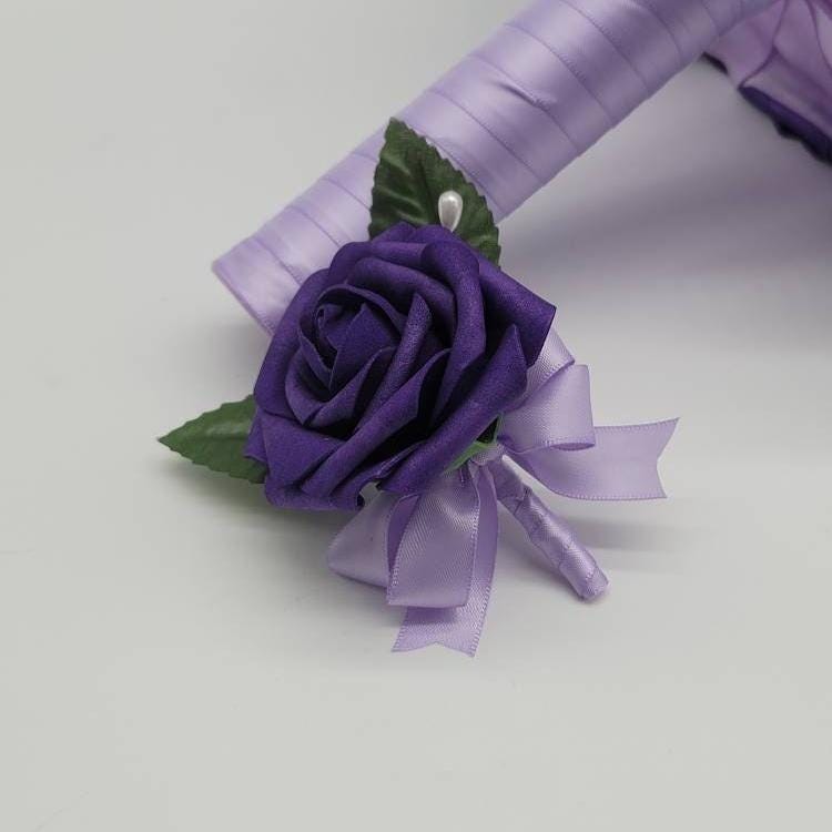 Dark purple boutonniere with lilac ribbon.