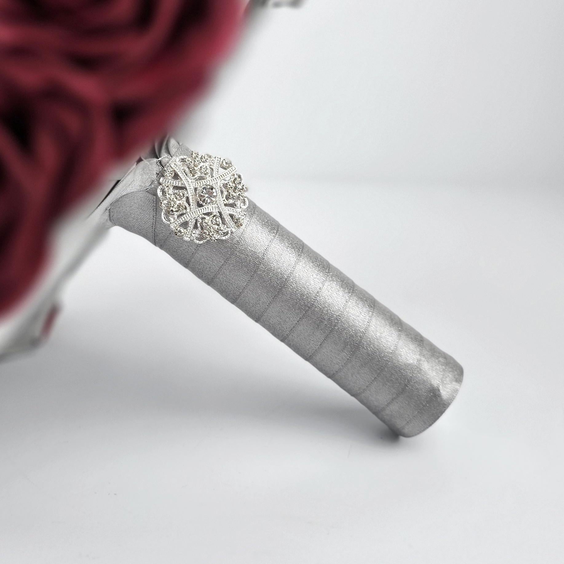 Silver ribbon handle with silver brooch