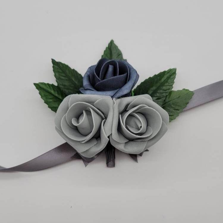 Dusty blue and gray wrist corsage with gray ribbon.