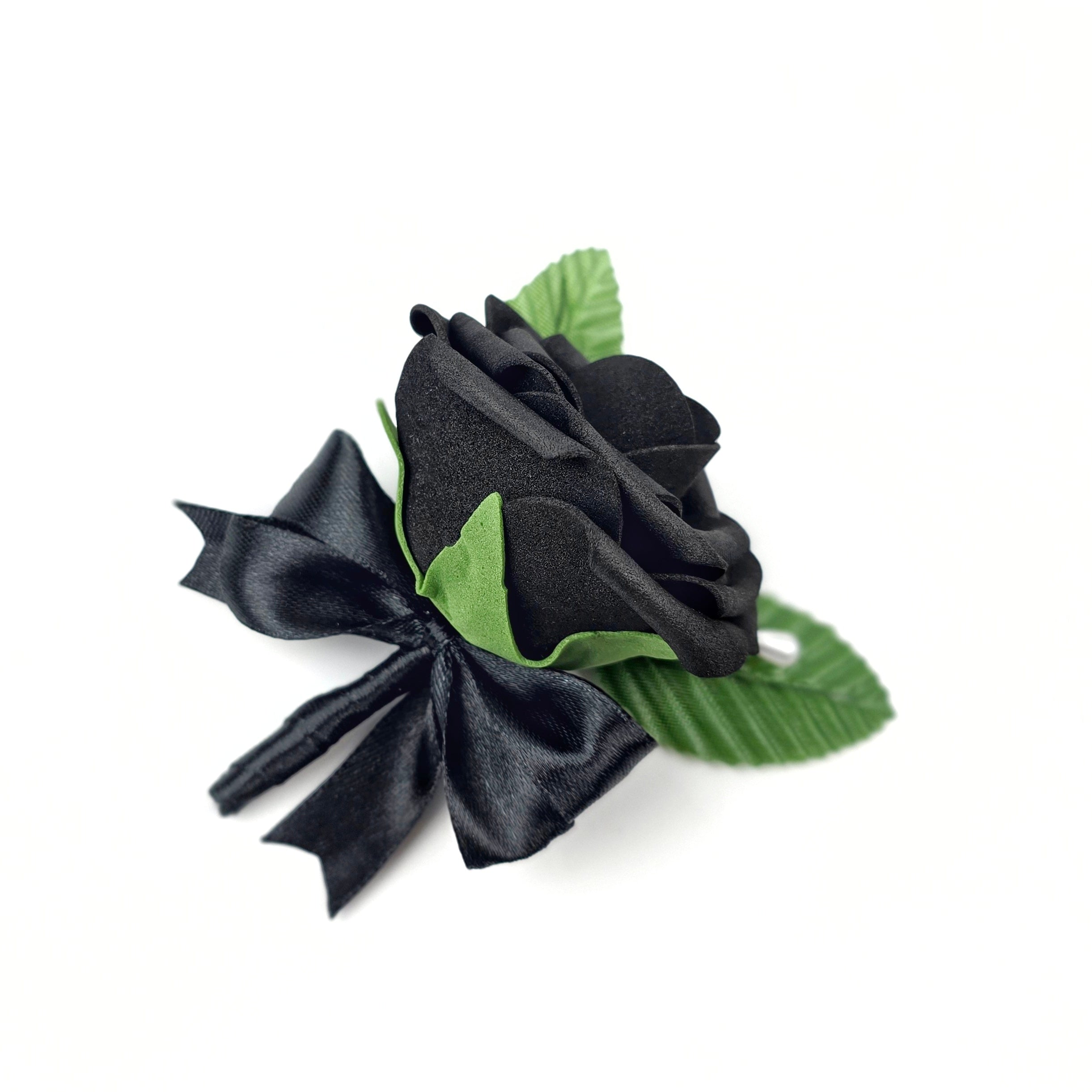 Black rose boutonniere with a pearl pin and 2 green leaves.