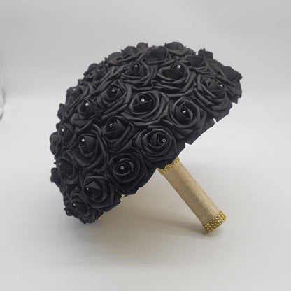 Black wedding bouquet with rhinestones on every rose. Handle is made up of gold ribbon and finished with gold bling wrap.