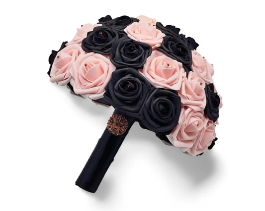 blush and black roses with rhinestones in the center of every rose. handle is made out of black satin ribbon and finished with gold brooh