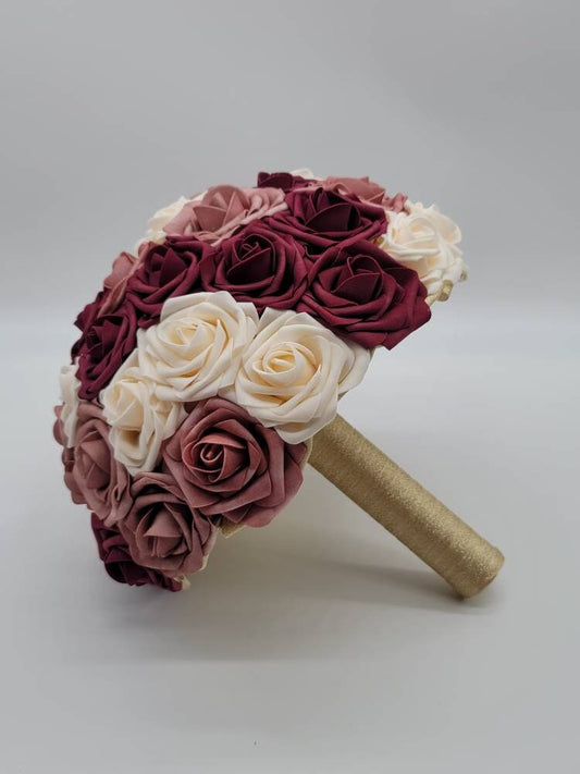 Burgundy, cream, and dusty rose bouquet. Handle is made out of gold ribbon