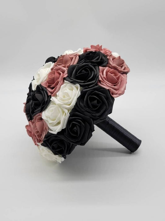 Dusty rose, black, and white roses with black satin ribbon