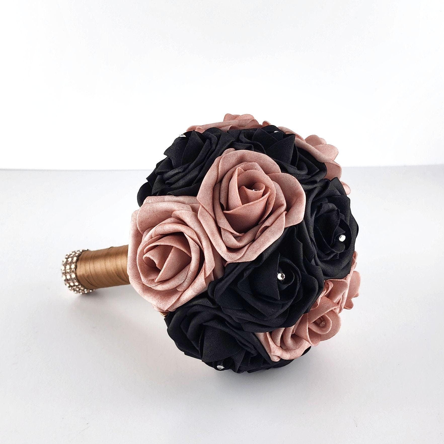 Dusty rose and black ribbon with rhinestones on every rose. Handle is made out of champagne ribbon and finished with rose gold bling wrap.