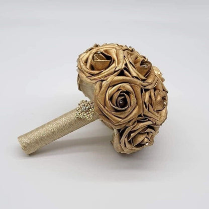 Gold bouquet with rhinestones on every rose. handle is made out of gold ribbon and finished with gold brooch