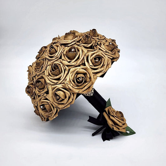 gold roses with rhinestones on every rose. handle is made out of black satin ribbon and finished with a gold brooch.