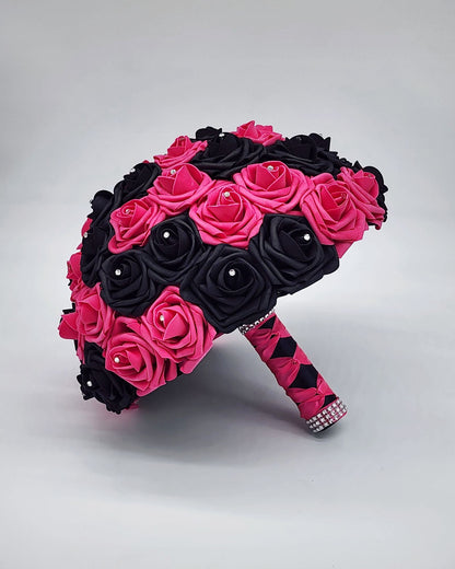 Hot pink and black rose bouquet with rhinestones on every rose. handle is made up of hot pink and black satin ribbon in a French twist style and finished with silver bling wrap.