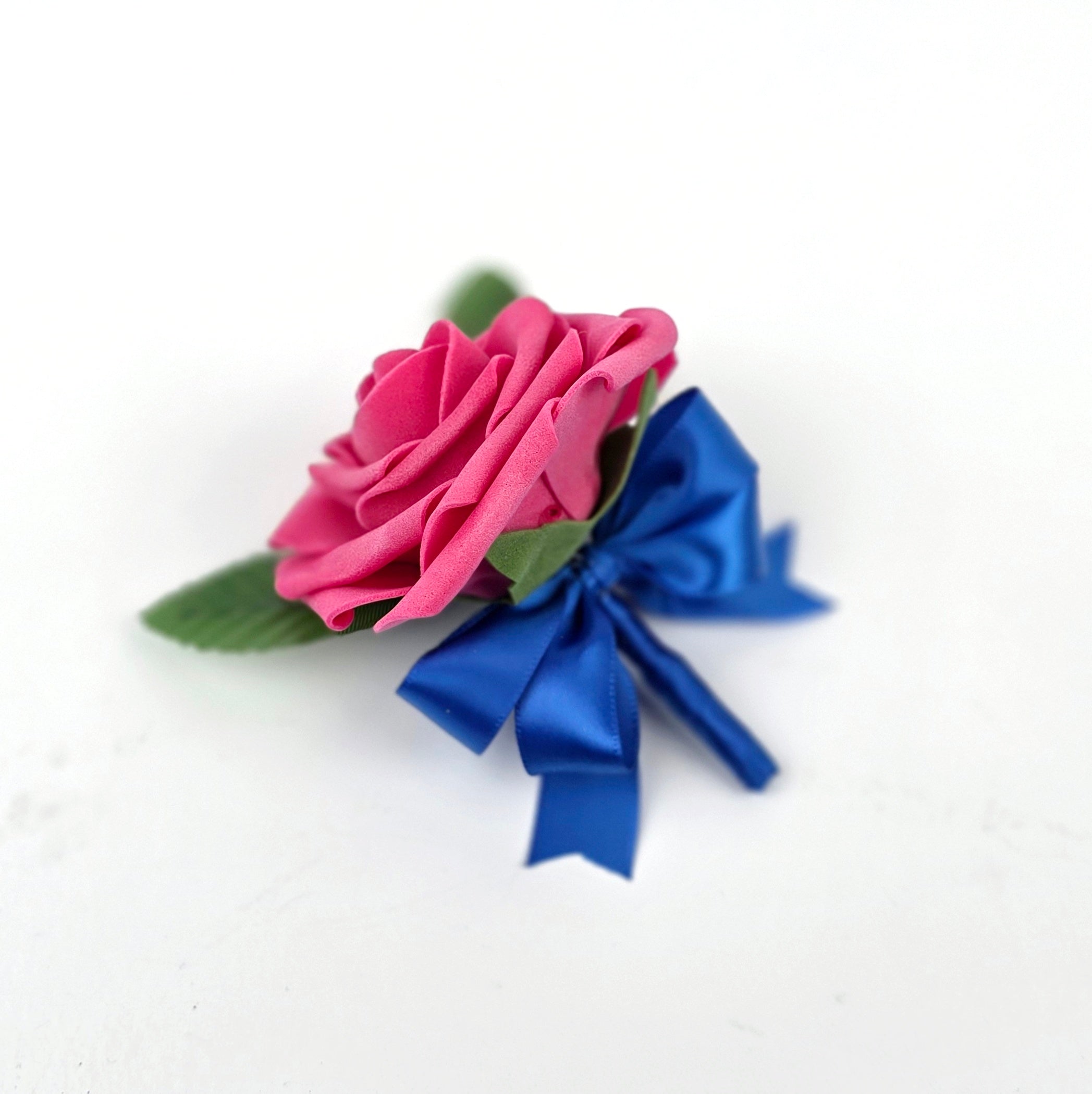 Hot pink boutonniere with royal blue ribbon and pearl pin