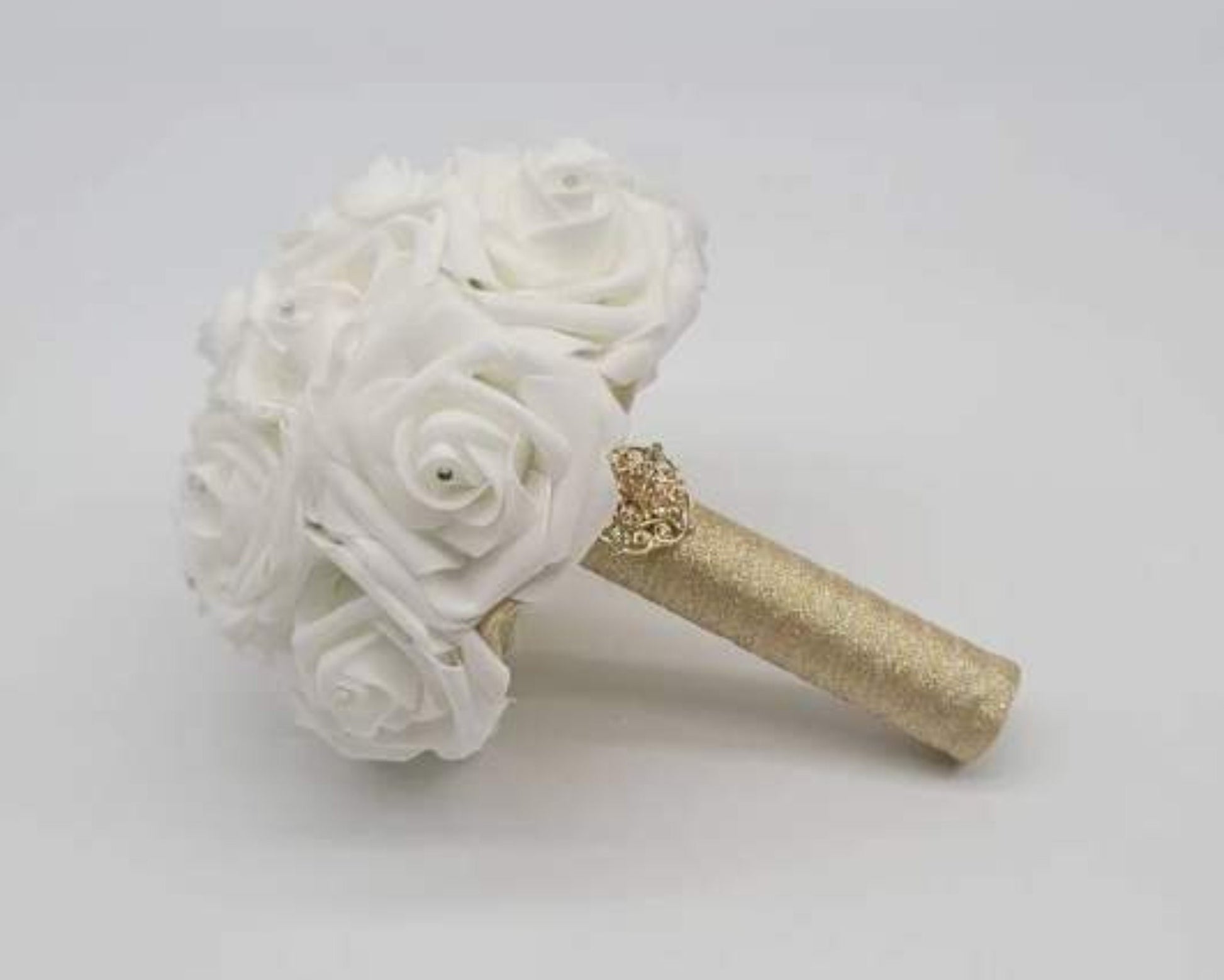 White Real touch rose bridal bouquet with rhinestones in every rose. Handle is made out of gold ribbon and finished with gold brooch.