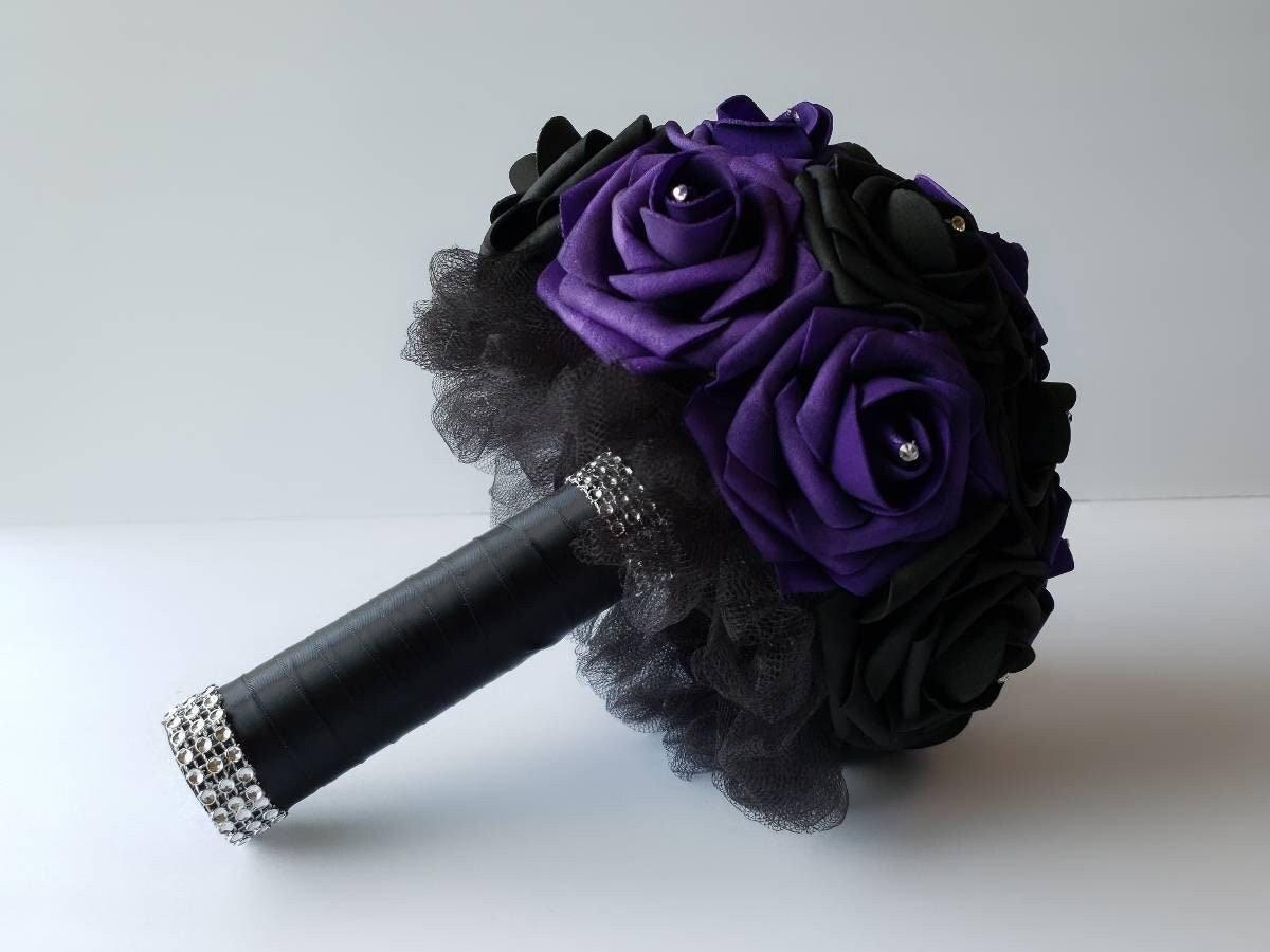 Purple and black wedding bouquet made with real touch roses. Handle is made out of satin black ribbon and tulle and finished with silver bling wrap. Rhinestones are placed on every rose.