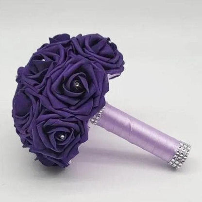 Purple real touch rose bridal bouquet with lavender ribbon and finished with silver bling wrap. Rhinestones are on every rose.