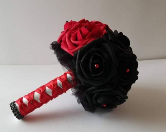 Red roses on one side, black roses on the other. Handle is made out of black tulle and red and white satin ribbon in a frech twist. black bling wrap on handle. red and black rhinestones on flowers