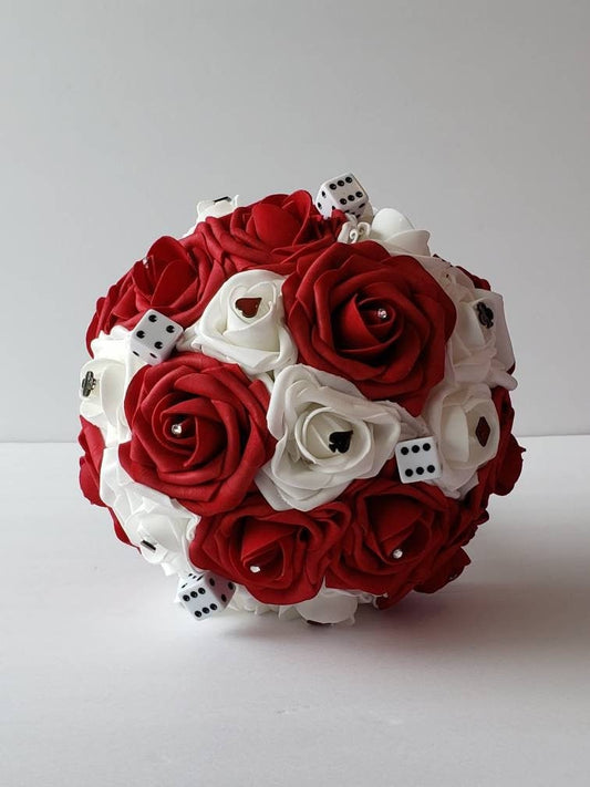 Red and white las vegas bridal bouquet made with real touch roses. Rhinestones, dice, and card suits are scattered throughout bouquet.