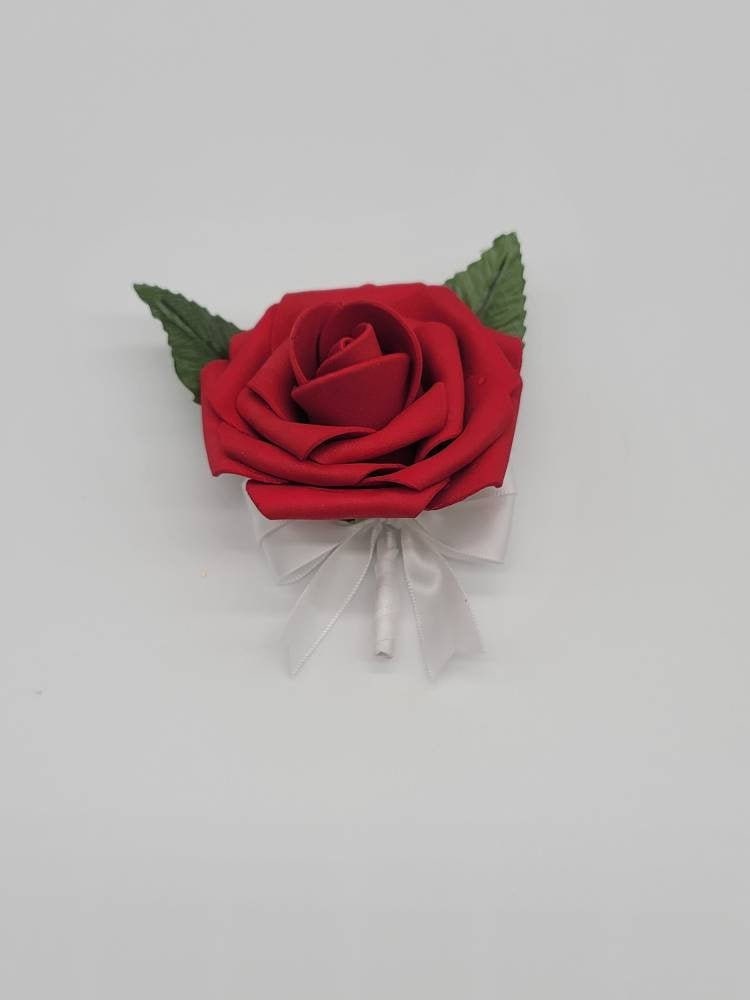 Red rose boutonniere with satin white ribbon made with Real touch roses. faux leaves and pearl pin