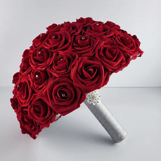 Red rose bridal bouquet with silver handle and silver brooch. Rhinestones on every rose.