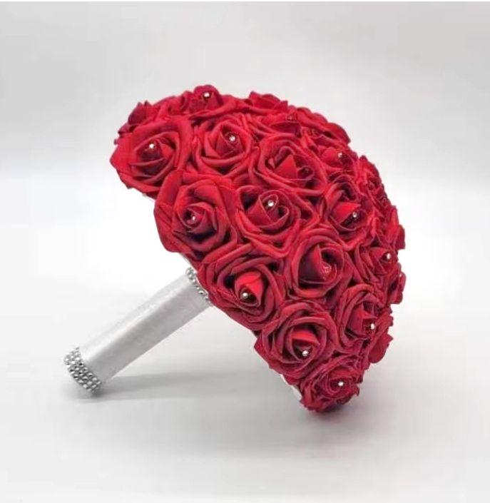 Red roses with rhinestones on every roses. Handle is made up of white satin ribbon and finished with silver bling wrap.