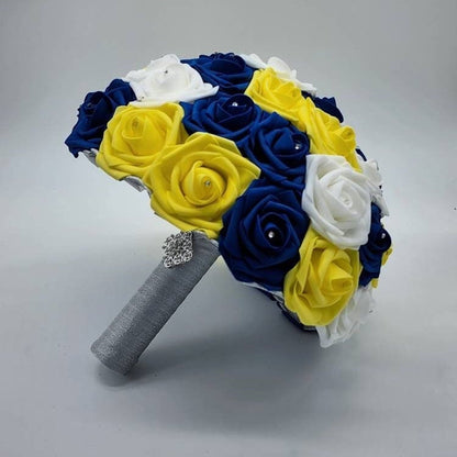 Royal Blue, yellow, and white bouquet with rhinestones on every rose. Handle is made up of silver ribbon.