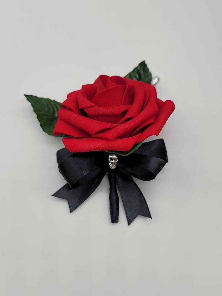 Red Real touch rose gothic skull boutonniere with black satin ribbon a silver skull accent.