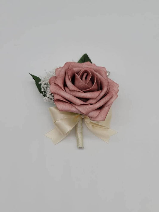 Dusty Rose Boutonniere with baby&#39;s breath. Ribbon is ivory satin ribbon. Pearl pin