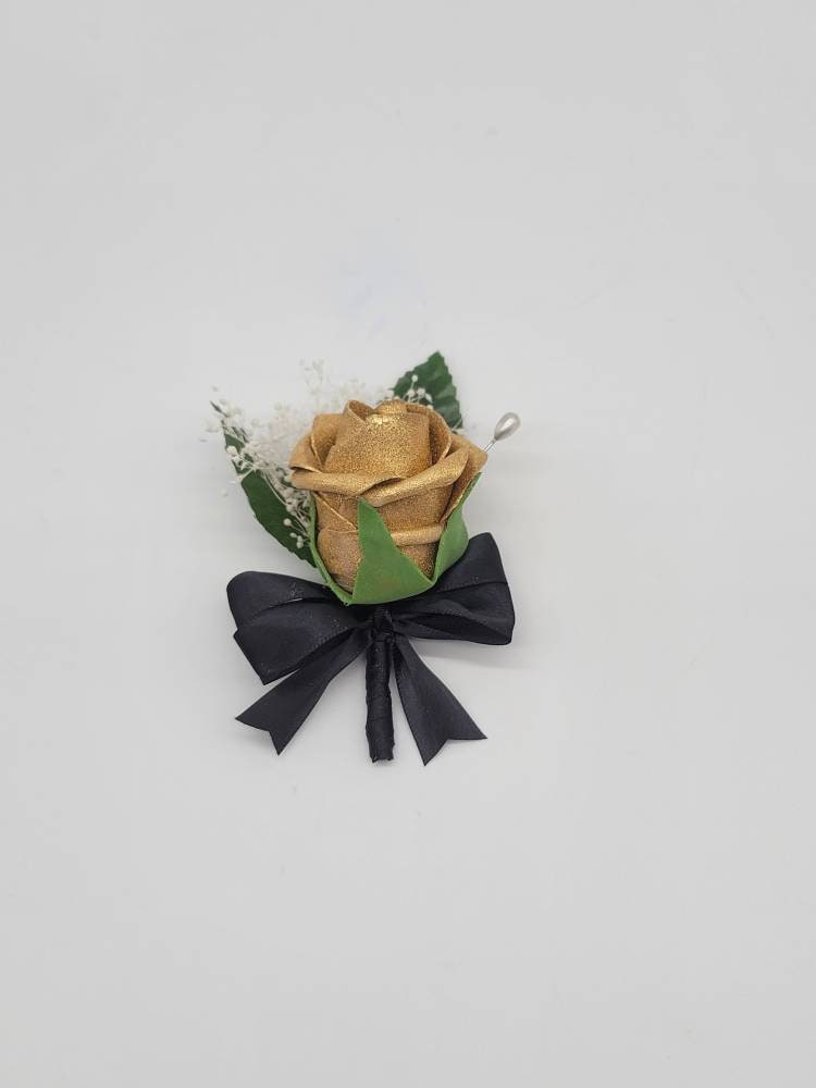 small gold boutonniere with baby's breath and black satin ribbon. pearl pin