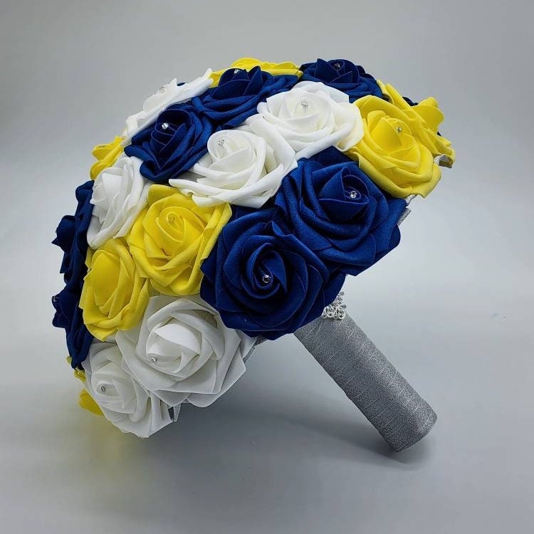 royal blue, yellow, and white bouquet with silver handle