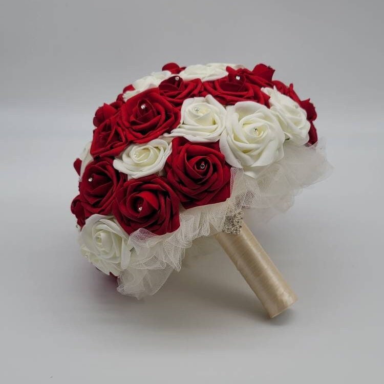 10 inch red and ivory side view. Silver brooch on handle