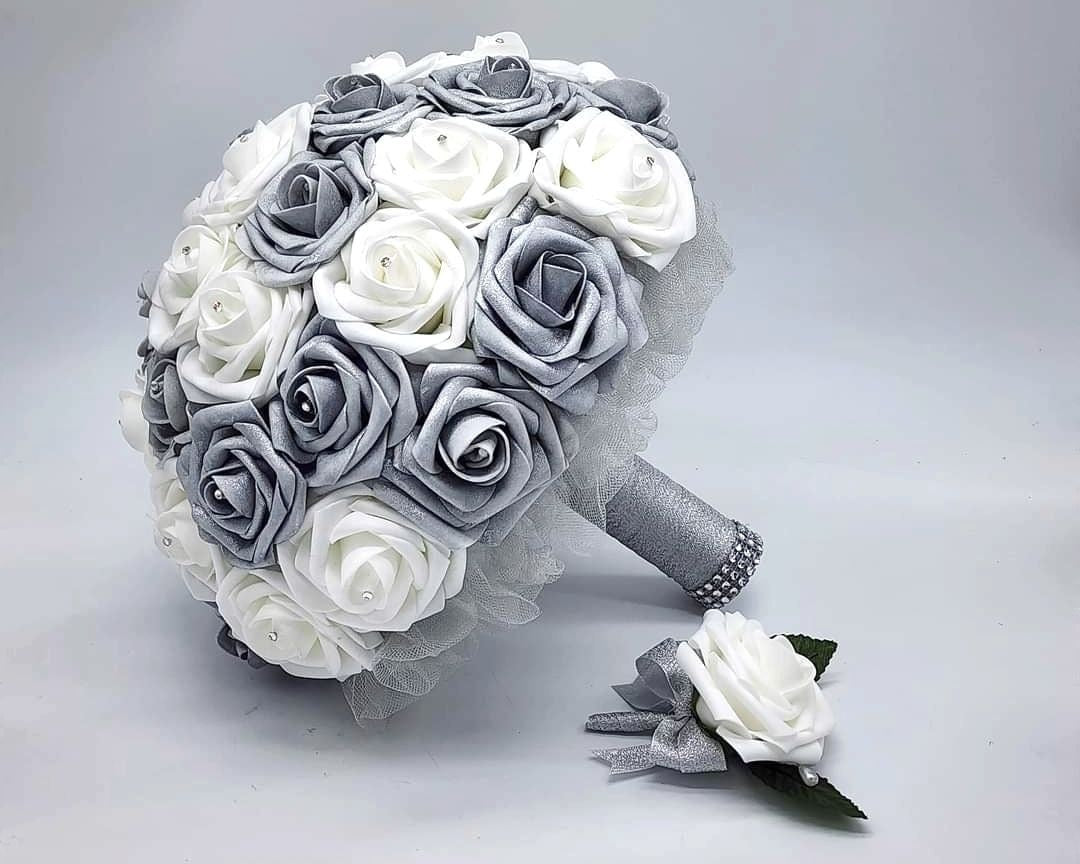 Silver and white rose bouquet with rhinestones on ever rose. Silver tulle and silver ribbon with bling wrap