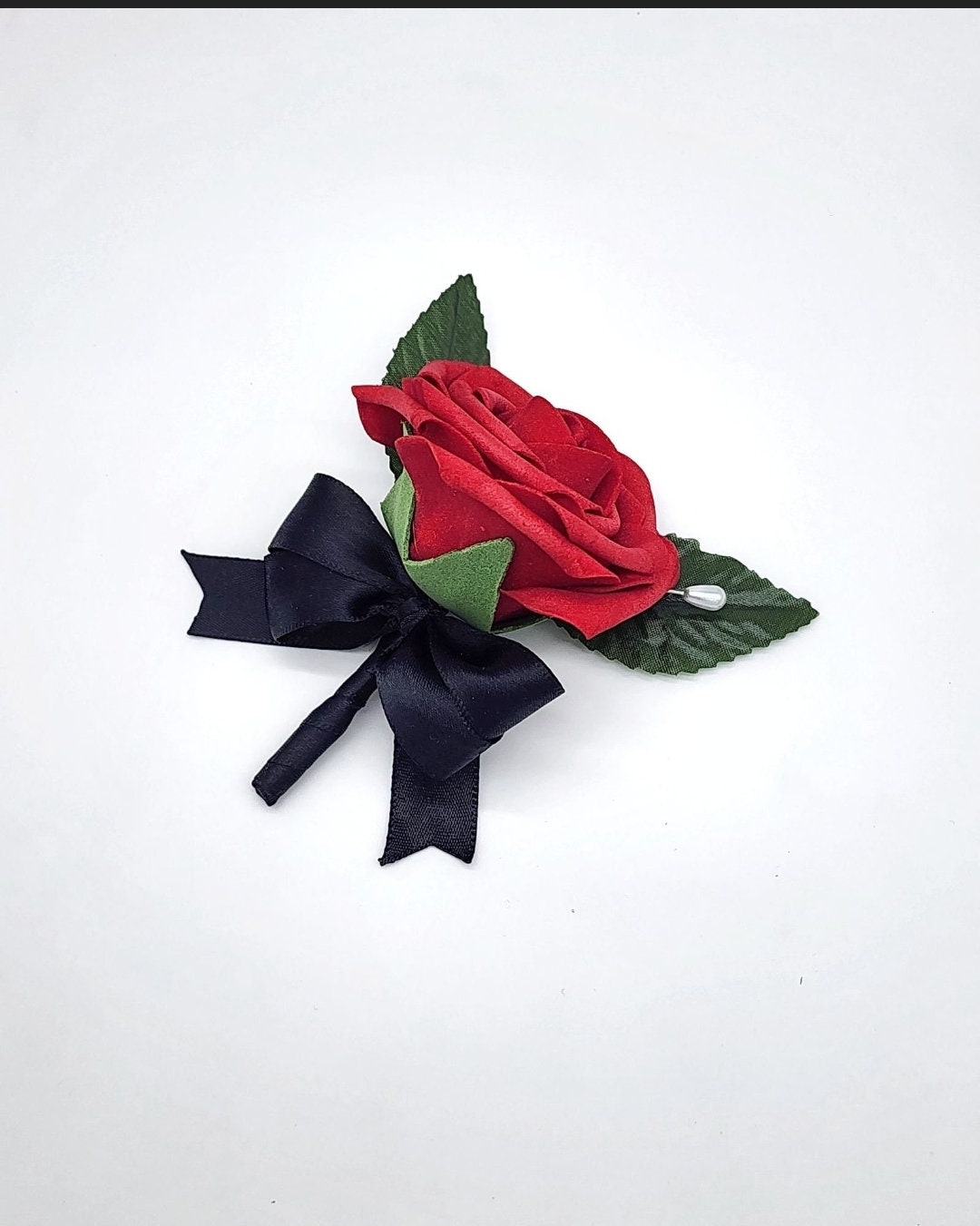 Men's red rose lapel pin with black satin ribbon.