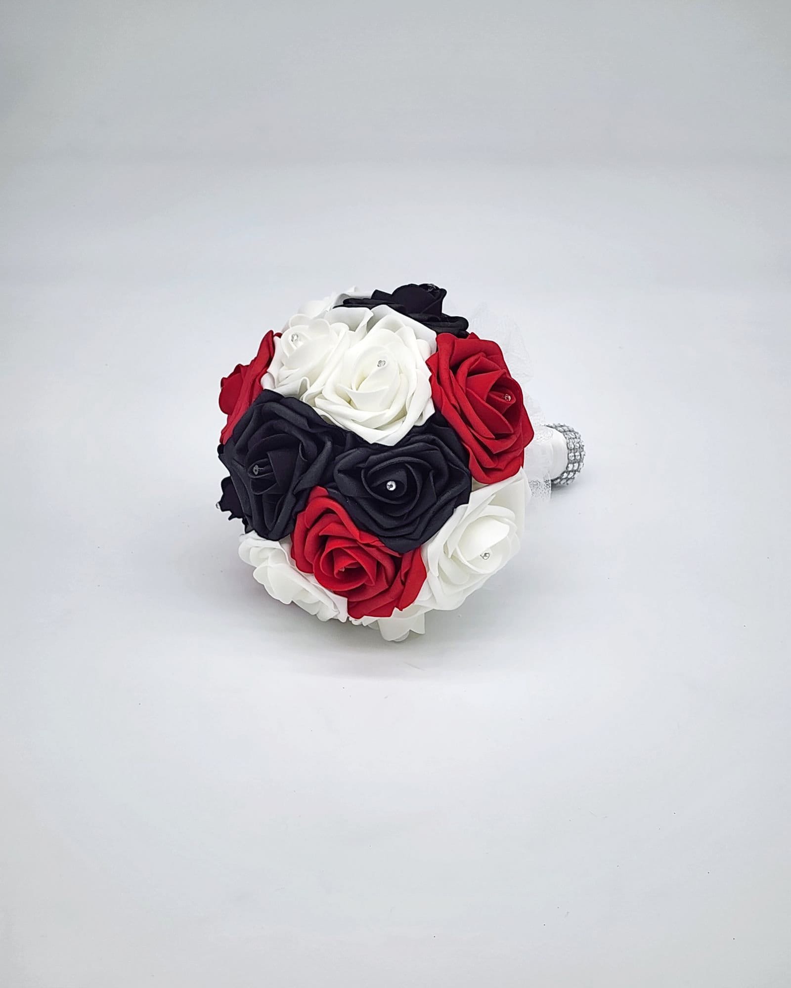 Red, black, and white wedding bouquet made with real touch roses. Bridal bouquet, bridesmaid bouquet, and matching boutonnieres and corsages