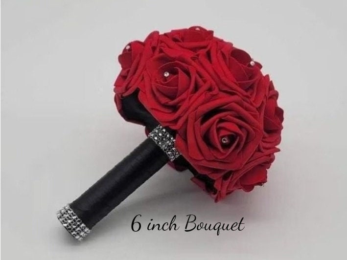 Red rose bouquet with black satin ribbon. Handle is finished with silver bling wrap. Rhinestones are in center of every rose. Great for weddings, brides, bridesmaids, prom, homecoming, Quinceanera's.