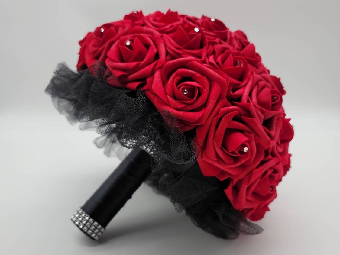 10 inches red wedding real touch roses with black satin ribbon handle. Silver bling wrap on the handle on top and bottom. Rhinestones are on every rose. Great for Bridal bouquets, Prom, Homecoming, Quinceanera's