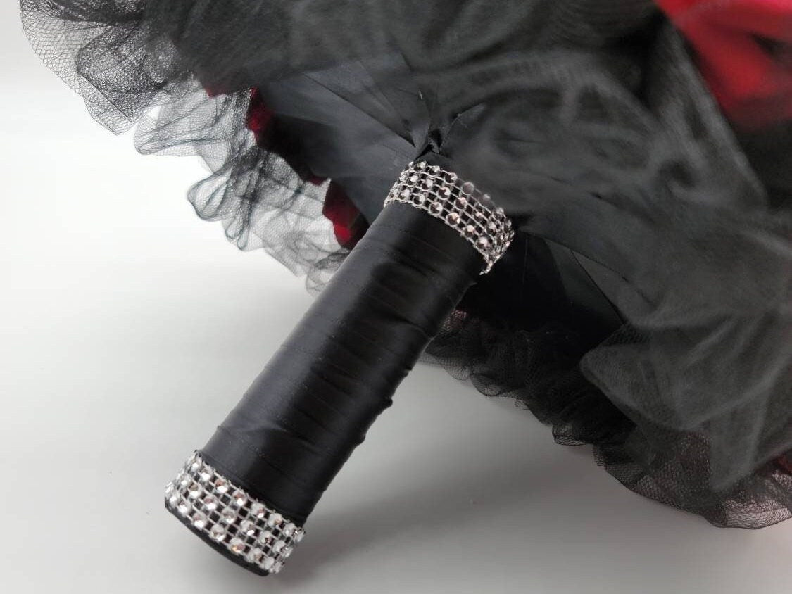 Picture of the black satin wrapped handle with the silver bling wrap on top and bottom.