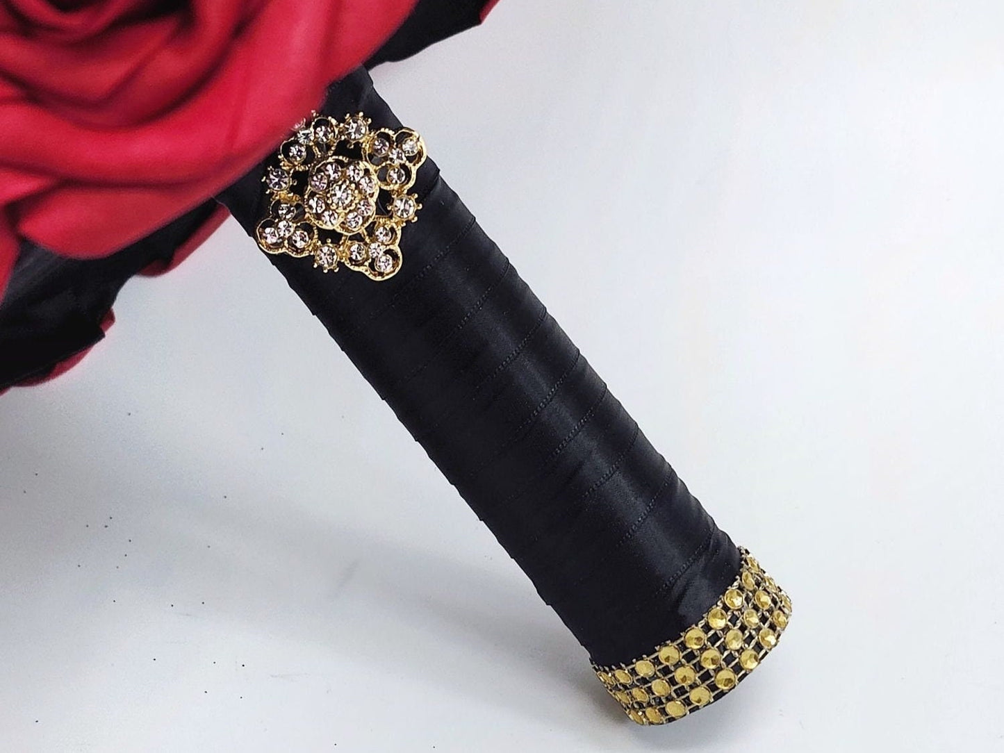 Bouquet handle-Black satin ribbon. Finished with a gold brooch and gold bling wrap.