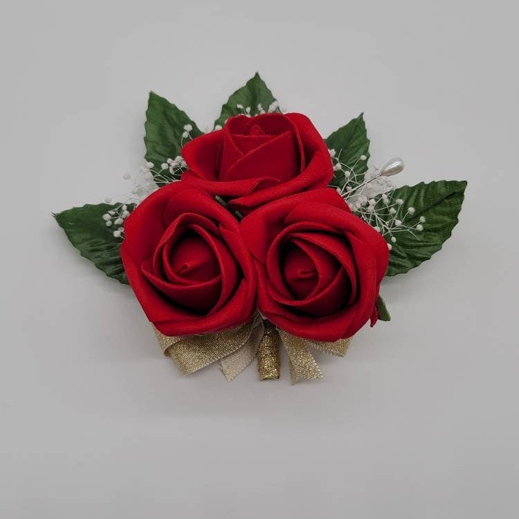 3 red rose bud pin on corsage with baby&#39;s breath and gold ribbon