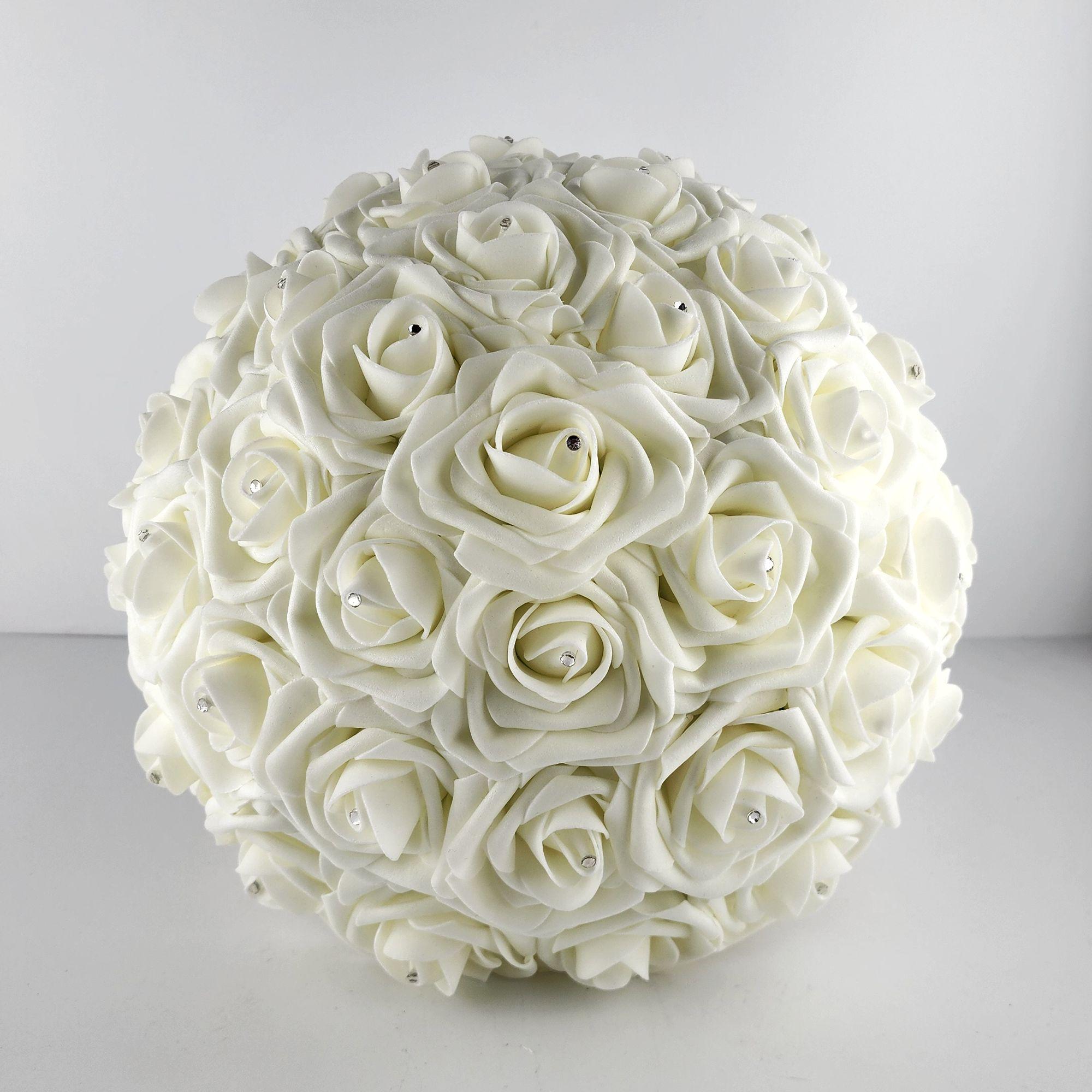 A ivory round bridal bouquet made of Real Touch roses with small silver rhinestones in the center of each rose.