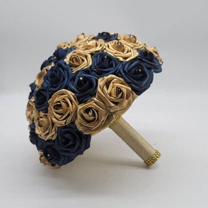 Gold and navy roses with rhinestones on every rose. handle is made up of gold ribbon and finished with gold bling wrap.