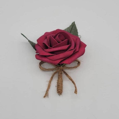 Berry wine red Boutonniere with 2 green faux leaves. Handle is made up of twine ribbon