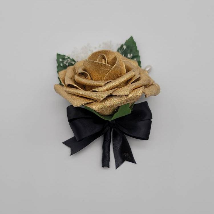 Gold and black boutonniere with baby's breath